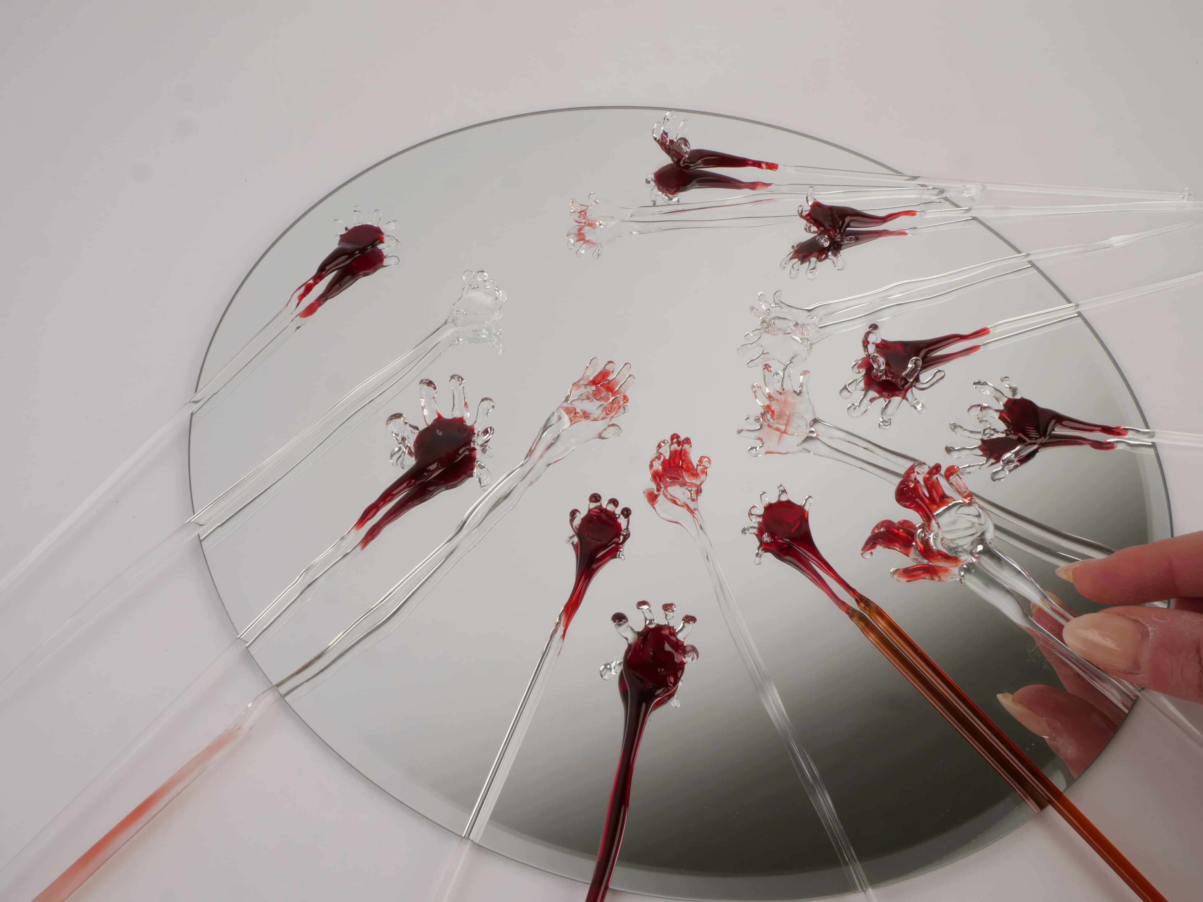 Glass hand sculptures on mirror